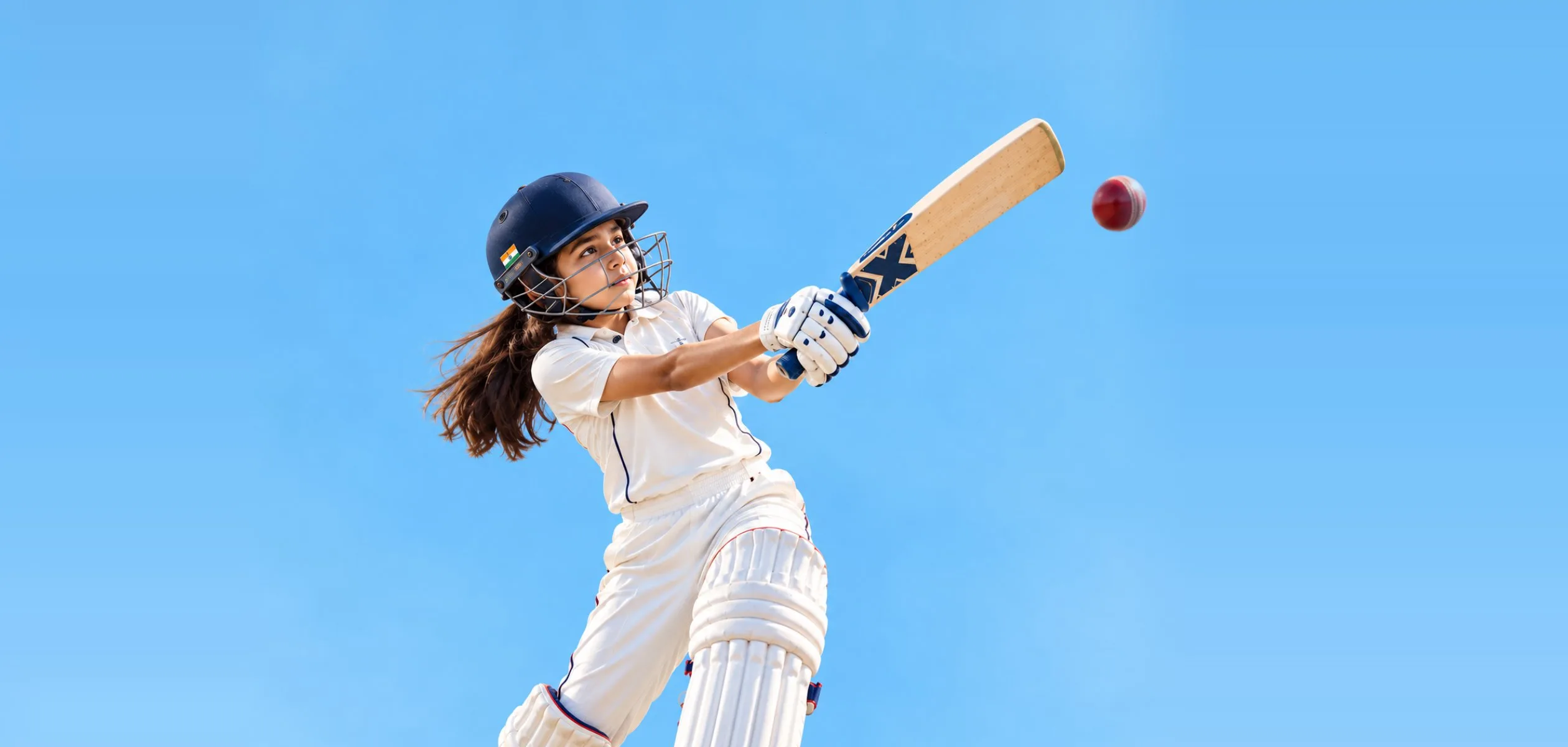 Girl batting against a blue sky